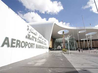 Marrakech Menara Airport terminal building exterior with Atlas Mountains backdrop