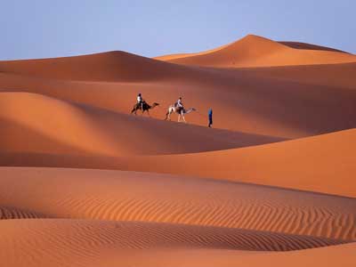 Towering orange sand dunes of Erg Chebbi desert at Merzouga Morocco